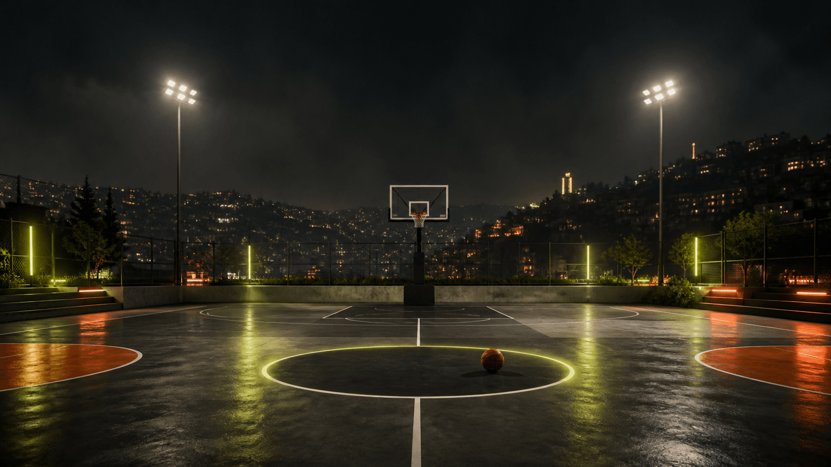 An empty basketball court at night overlooking Amman